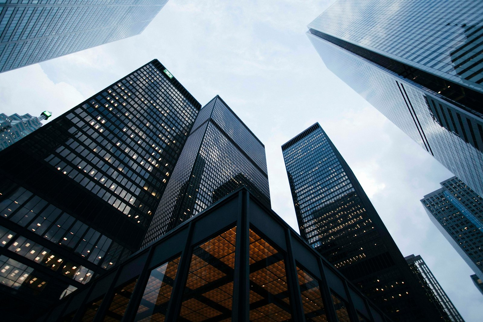 Architectural photograph looking upward between glass buildings